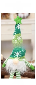 Detail of a Christmas gnome with green knitted hat, white beard and star decoration