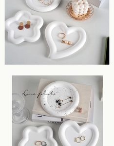 Detailed view of white ceramic heart and flower shaped jewelry display trays