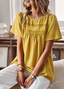 Close-up of yellow puff sleeve blouse featuring intricate lace splicing and textured fabric