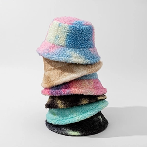 Various tie-dye lamb wool bucket hats for winter showing fluffy textures in multiple colors