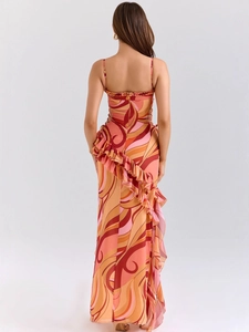 Women's backless halter maxi dress featuring warm-toned abstract swirl prints and ruffles