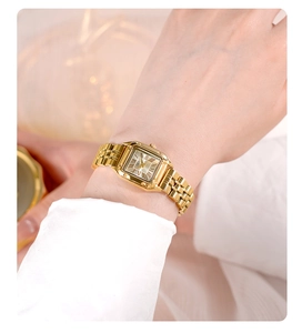 Macro shot of elegant gold square watch featuring Roman numerals and metal link strap