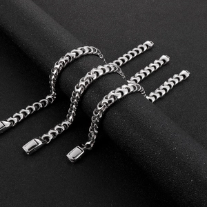Polished hip hop style silver stainless steel Cuban link bracelets on black background
