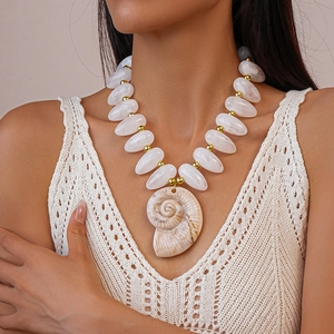 Detail of bohemian acrylic white beaded necklace with large resin conch seashell pendant