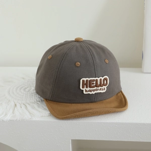 Close-up of contrast color cotton baby cap with HELLO embroidery and soft brim