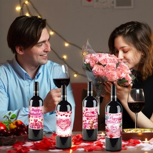 Macro detail of four romantic Valentine's Day wine bottle labels in a cozy dinner setting