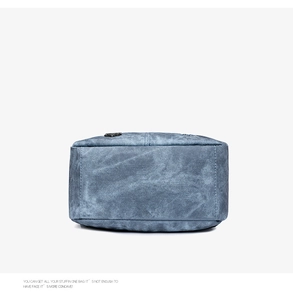 Macro shot of blue washed soft leather texture with vintage stitching on women's backpack