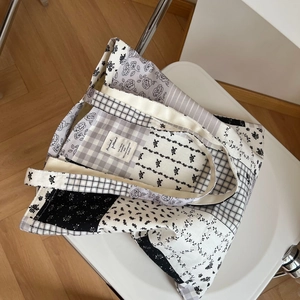 Floral patchwork canvas tote bag with black and white patterns and shoulder strap