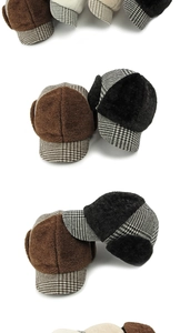 Detail view of winter earflap hats in brown, black, and beige with plaid splicing fabric