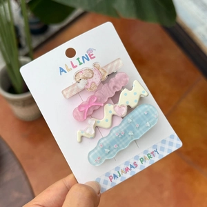 Set of 4 colorful acrylic hair clips with pink bear and floral bow patterns on display card