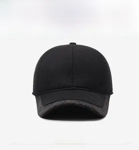 Detail of winter baseball cap featuring black knit fabric and silver shield emblem
