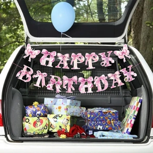 Pink bow Happy Birthday banner hanging in a decorated car trunk for party outdoor celebrations