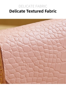 Macro shot of pink crocodile pattern leather texture and gold chain on a small square bag