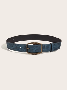 Detail of dark blue embossed leather belt with vintage floral and bull head patterns