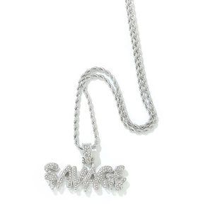 Macro shot of silver Savage letter pendant with shiny rhinestones and twisted rope chain