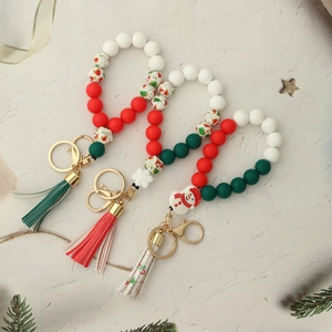 Close-up of Christmas silicone bead keychain with snowman charms and festive tassels