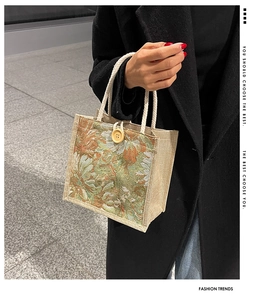 Close-up of linen tote bag with vintage floral jacquard and wooden button detail