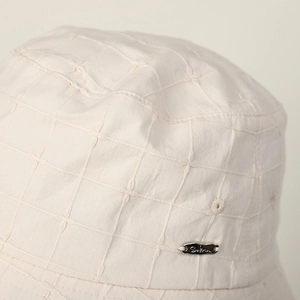 Beige cotton linen bucket hat with embroidered plaid pattern and silver metal label