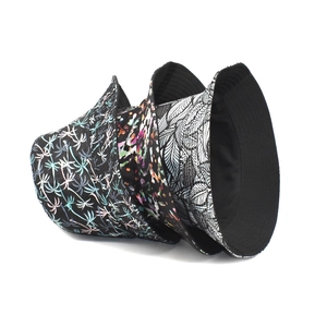 Reversible bucket hat with tropical palm and abstract prints with black inner lining