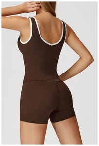 Detailed back view of a dark brown racerback yoga vest with white contrast piping