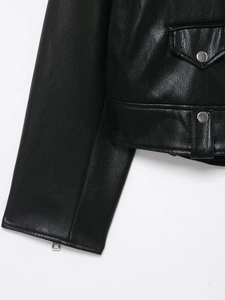 Close-up of black leather biker jacket showing high-quality texture and silver metal fasteners