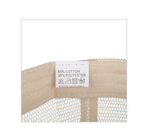 Detail of baseball cap interior mesh fabric with cotton blend wash care label