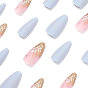 Matte almond press-on nails in lavender and pink gradient with gold foil and white leaves