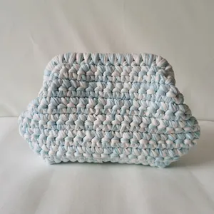 Macro detail of hand-knitted cloud bag showing blue and white cotton fabric texture