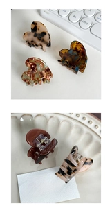 Detail of heart-shaped tortoiseshell and marble acetate hair claws with handmade texture