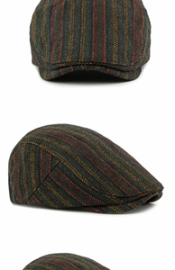Detail of vintage wool flat cap with dark green tweed texture and colorful stripes