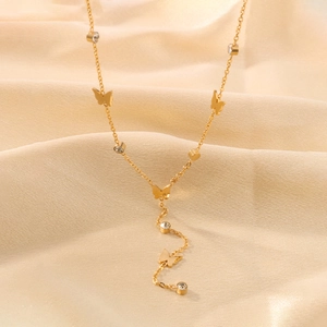 18K gold plated butterfly pendant necklace with shimmering crystals on silk background