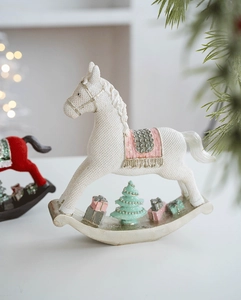 Detail of white resin rocking horse with pink saddle and textured woven finish