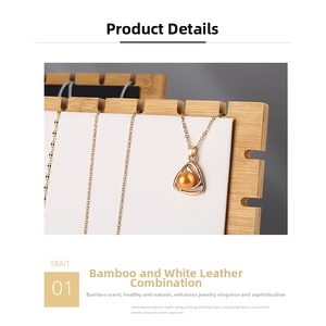 Detail of bamboo necklace display stand with white leather slots for jewelry storage