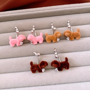 Detail of three pairs of flocked puppy earrings with heart-shaped crystal pendants