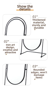 Close-up of the black iron frame detail and smooth arc edge of the desktop vanity mirror