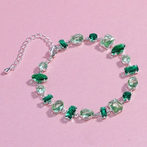 Detail of silver chain bracelet with mixed green zircons in waterdrop and round cuts