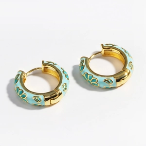 Detail of light blue enamel floral earrings with gold trim and hinged hoop design