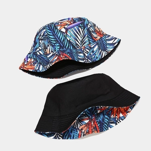 Reversible tropical print bucket hat with blue floral and solid black cotton design