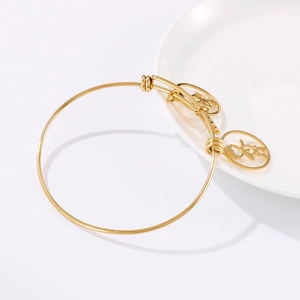 Adjustable 18k gold plated stainless steel bracelet with hollow figure charm on white tray