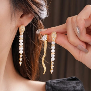 Elegant long tassel earrings featuring gold plating, white pearls and zircon stones