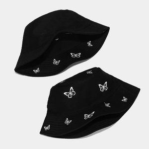 Reversible black bucket hat with white butterfly embroidery for sun protection