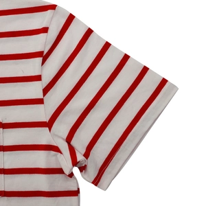 Detailed view of sleeve seams and pocket edge on red and white striped cotton t-shirt