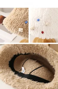 Detail view of plush bucket hat featuring cute bear patch and internal adjustable strap