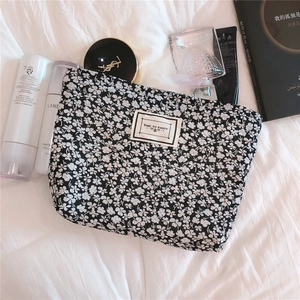 Close-up of black floral puff cotton makeup bag with Time to Party patch detail