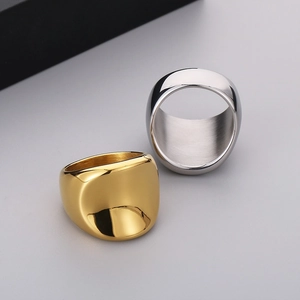 Polished 18K gold and silver wide band rings in stainless steel shown from a 45-degree angle