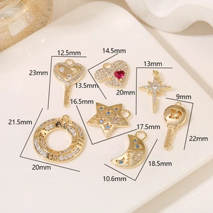 Various 14K gold plated Cupid arrow and heart charms with zircon inlay on white tray