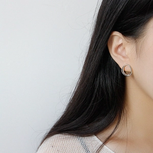 Minimalist S925 sterling silver geometric double hoop earrings worn by a model