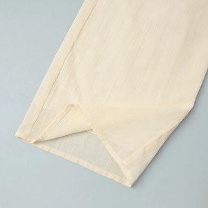 Detail showing the vertical striped texture and stitching on beige linen shirt sleeve