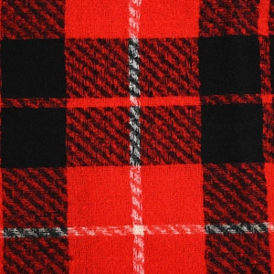 Close-up of red and black plaid faux cashmere fabric texture with fringe details