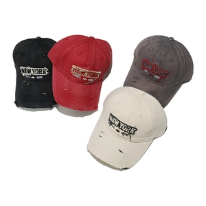 Detailed view of vintage distressed baseball caps in black, red, gray and beige colors